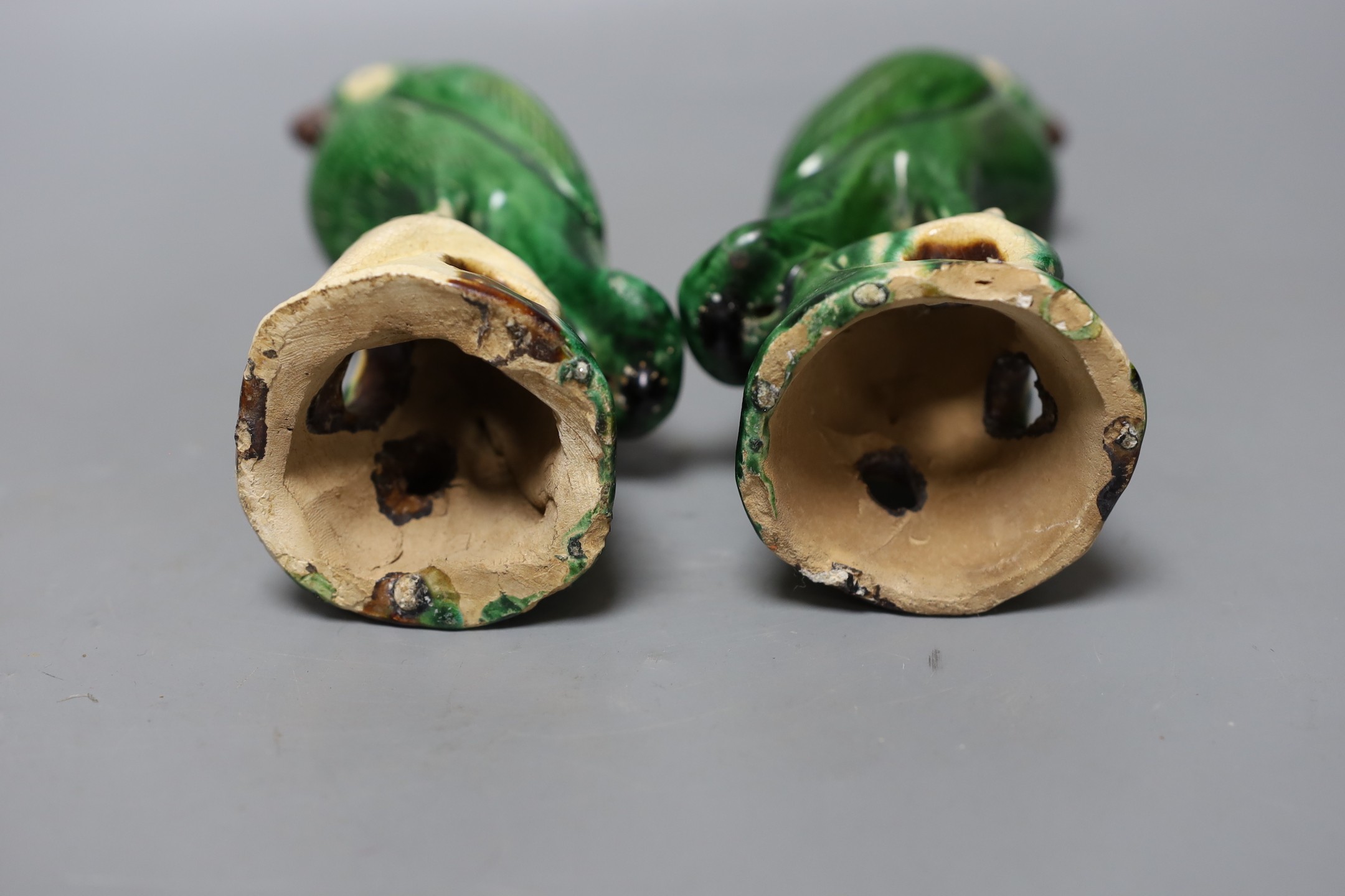 A pair of 19th/20th century Chinese sancai stoneware parrots, 22cm